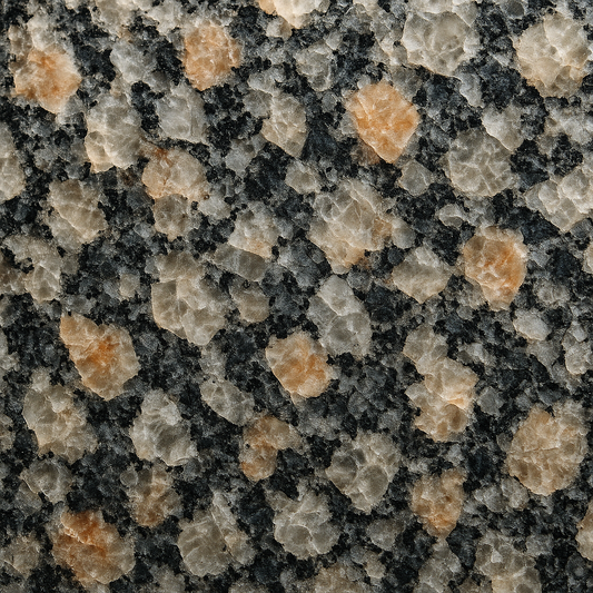 Macro close-up of a polished granite countertop revealing interlocking quartz and feldspar crystals under directional lighting