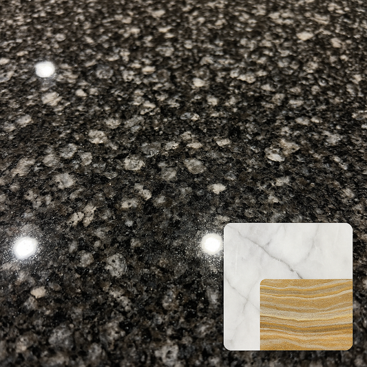 Macro view of polished granite showing interlocking feldspar, quartz, mica crystals alongside smaller insets of marble calcite crystals and quartzite layers