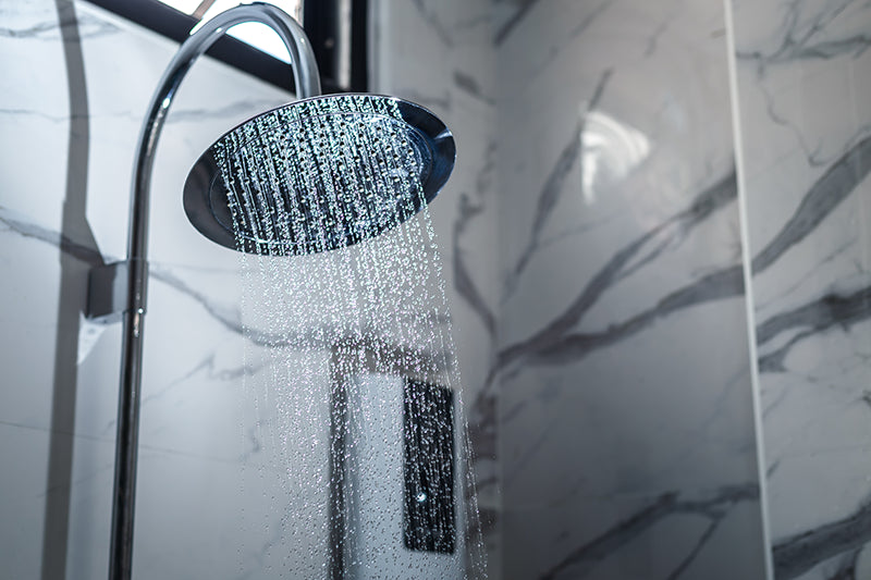 Custom shower installation with stone and glass